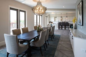 Rooftop clubroom with outdoor patio, catering kitchen, oversized dining table and communal living room with fireplace & tv